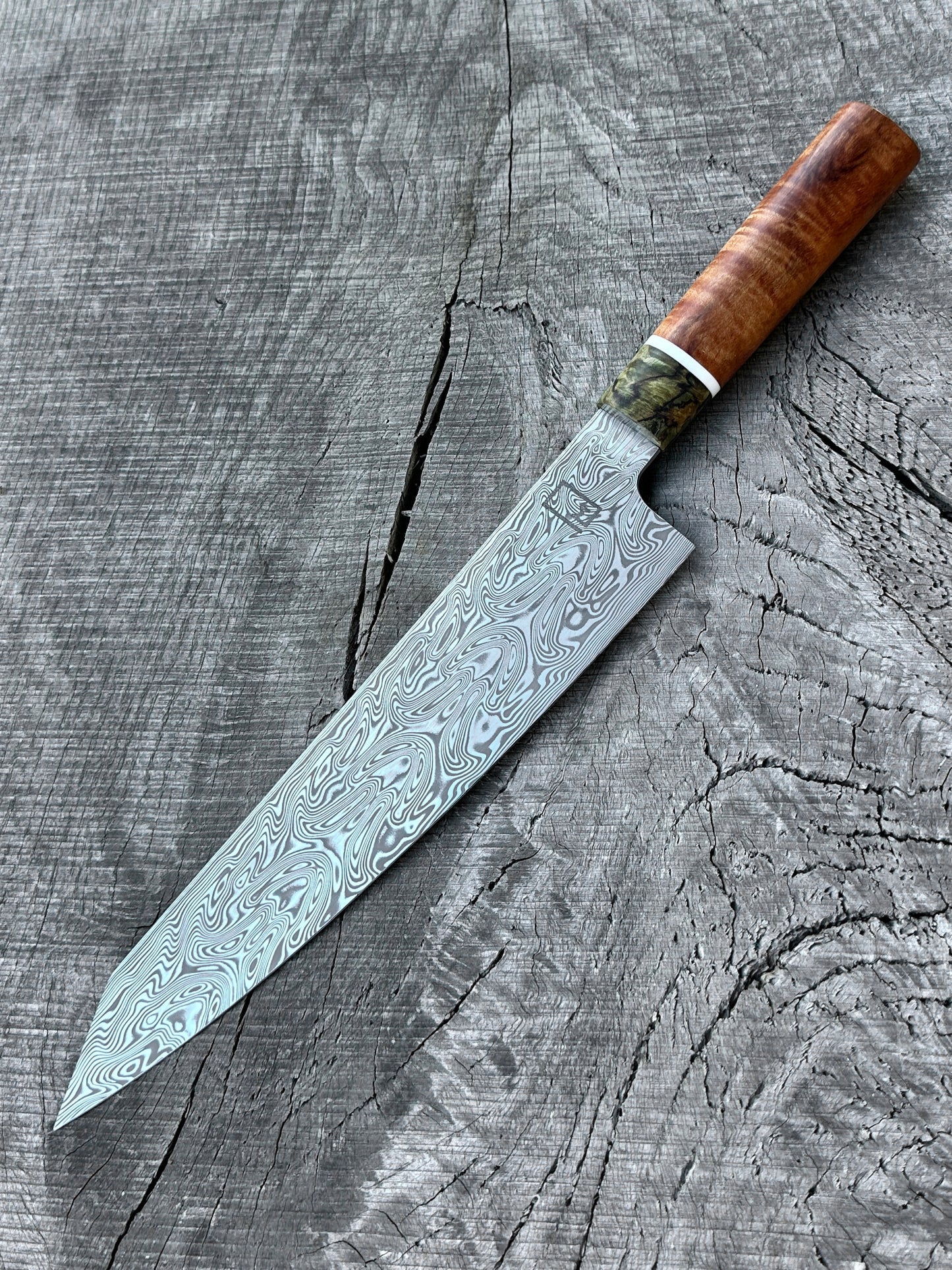 240mm/9.5" Kiritsuke with Damasteel and handle made of Koa, Corian, and Spalted Maple